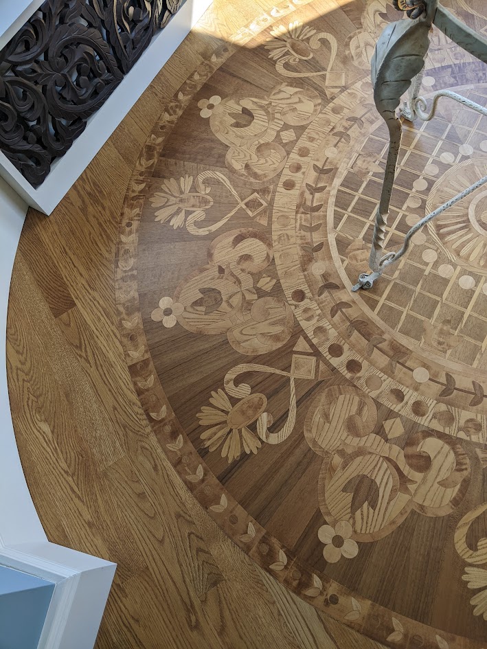 A wooden floor with ornate designs etched into it