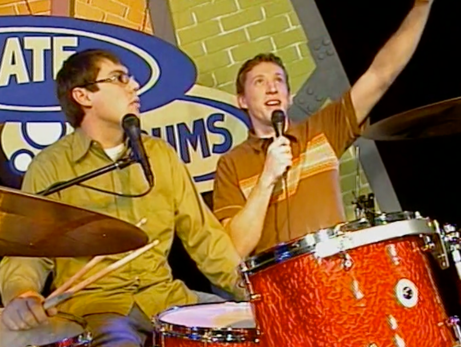 Two cast members on the set of Nate on Drums.