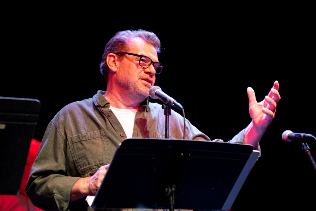 Lee Adams speaks into a microphone during Granite City Radio Theatre