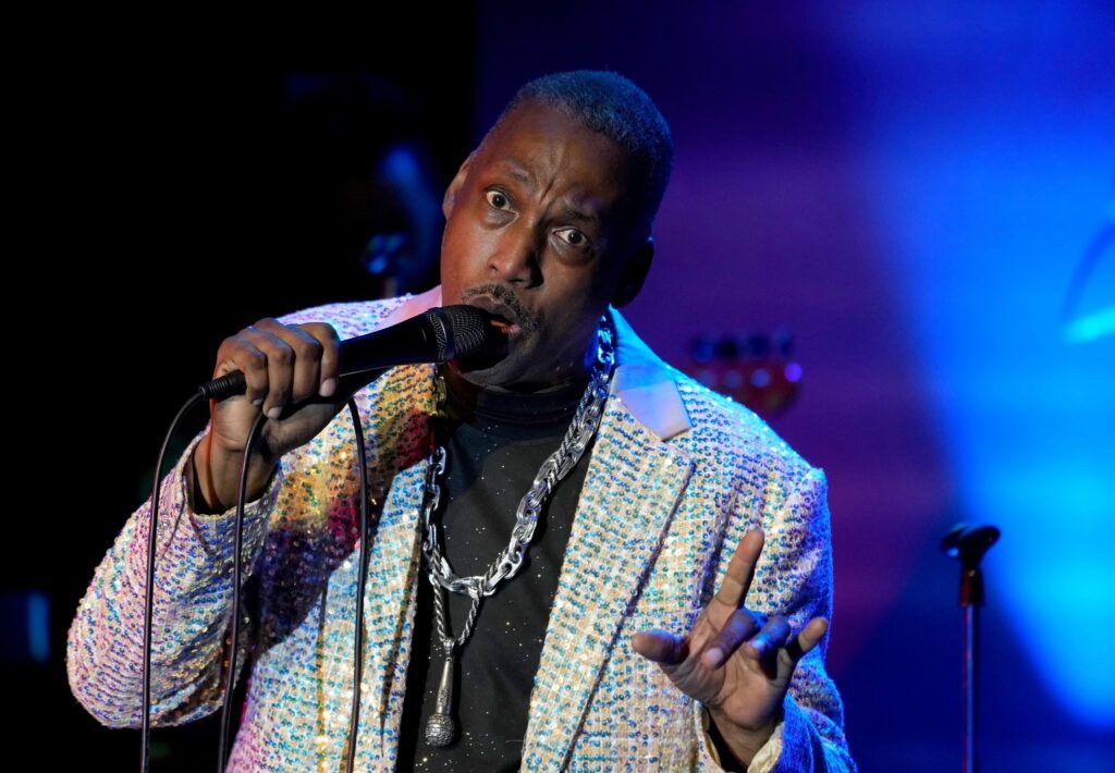 Jaybee sings into a microphone