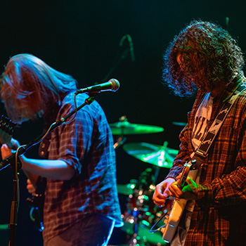 Band members performing live on stage