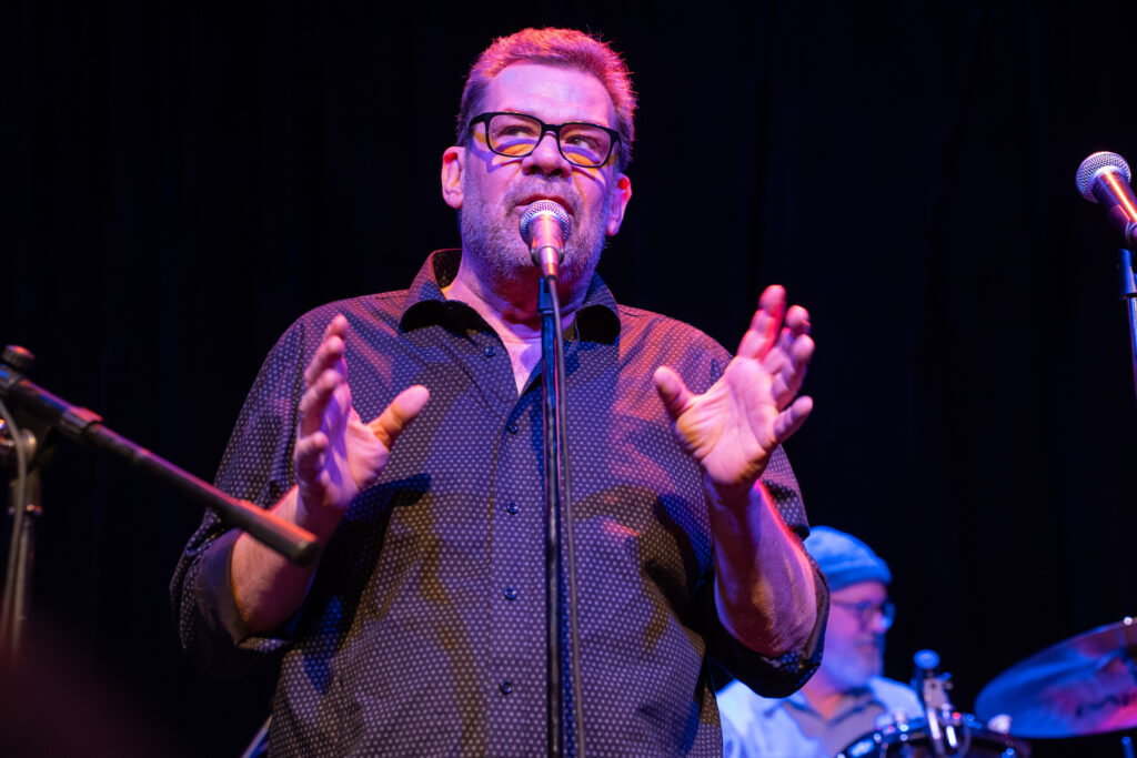 Lee Adams speaks into a microphone