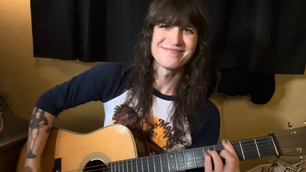 Sofia Martin holds her acoustic guitar
