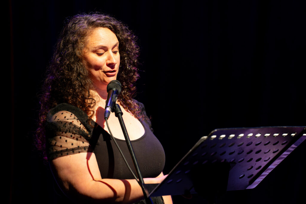 Heather Mastromarco speaks into a microphone