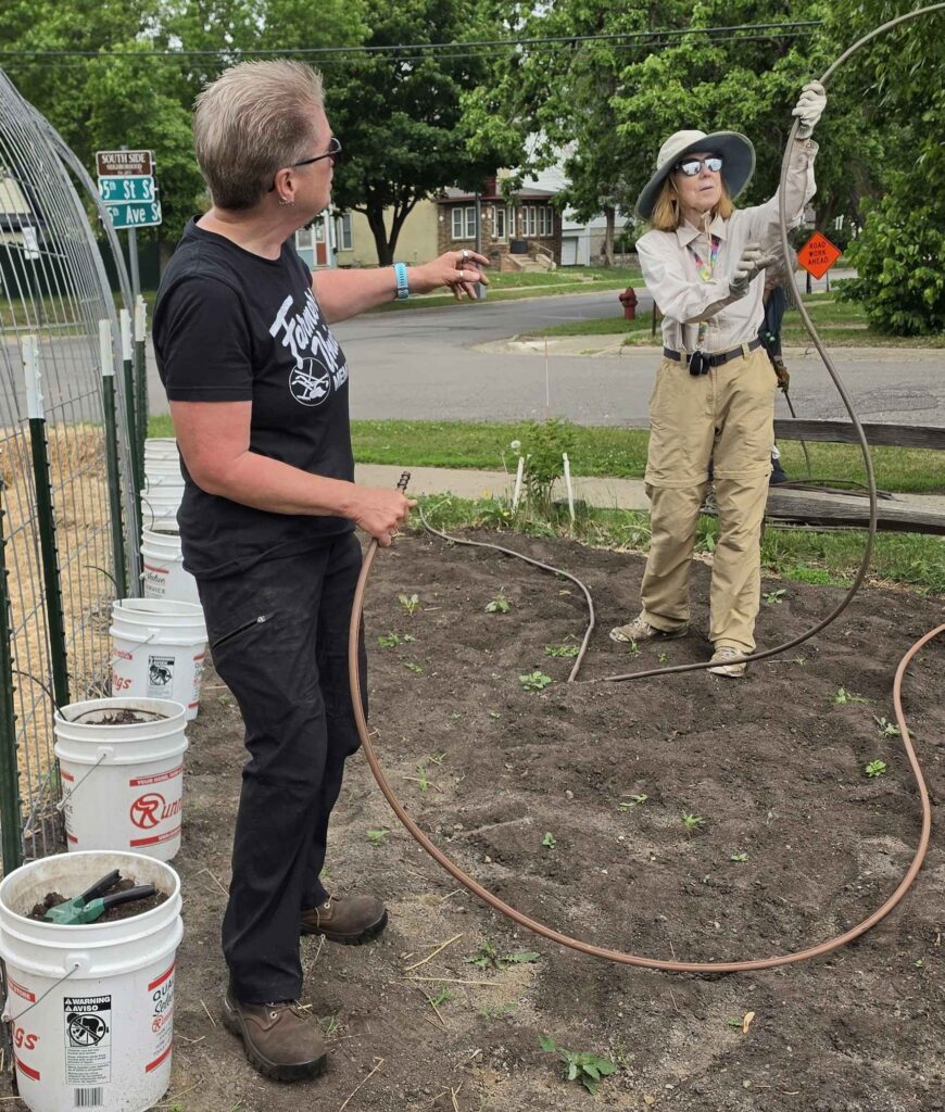 Community Garden Director Tracy Ore directs volunteer 