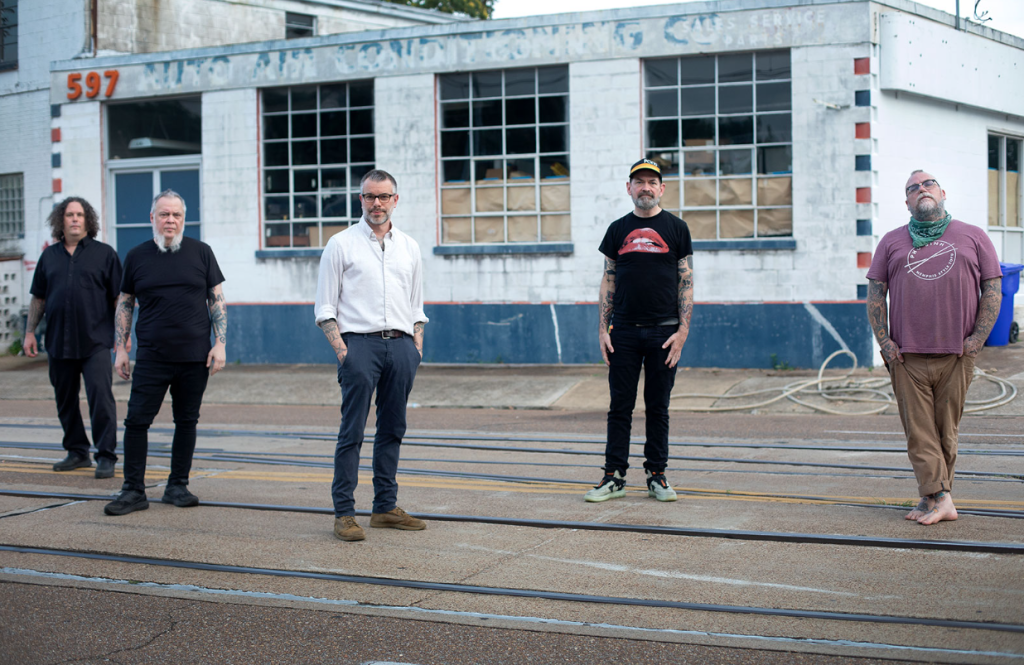 The five members of Lucero stand on a street