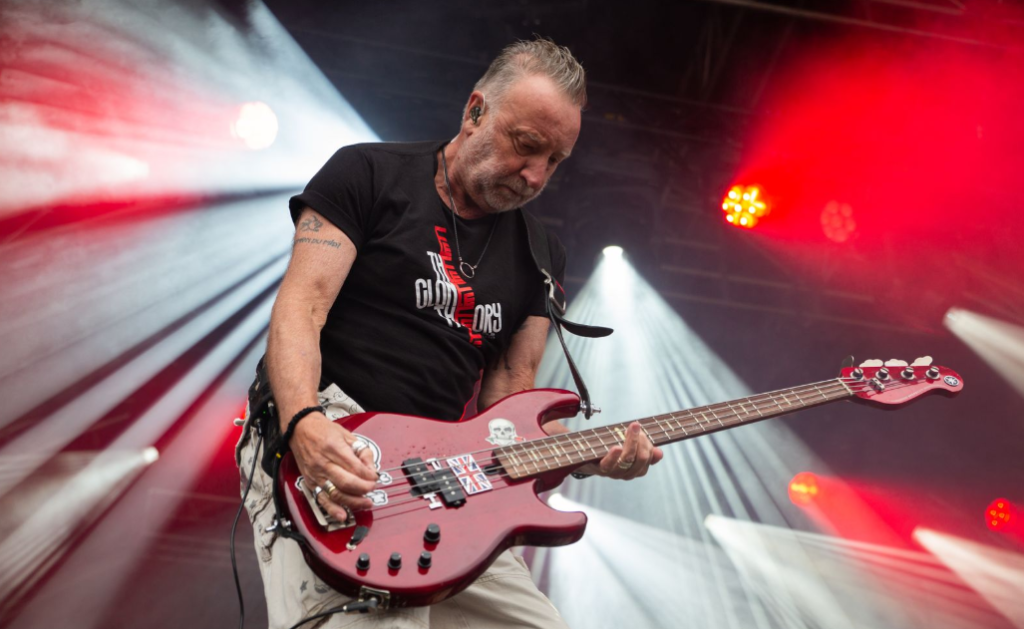 Peter Hooks plays his bass on stage