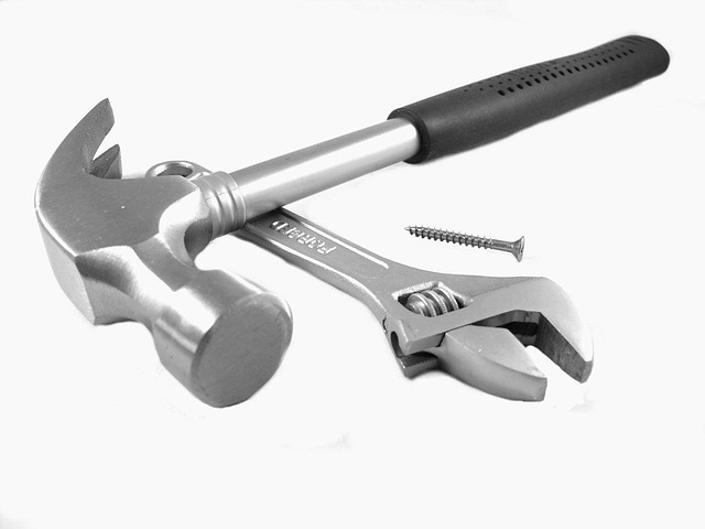 A hammer, an adjustable wrench, and a screw